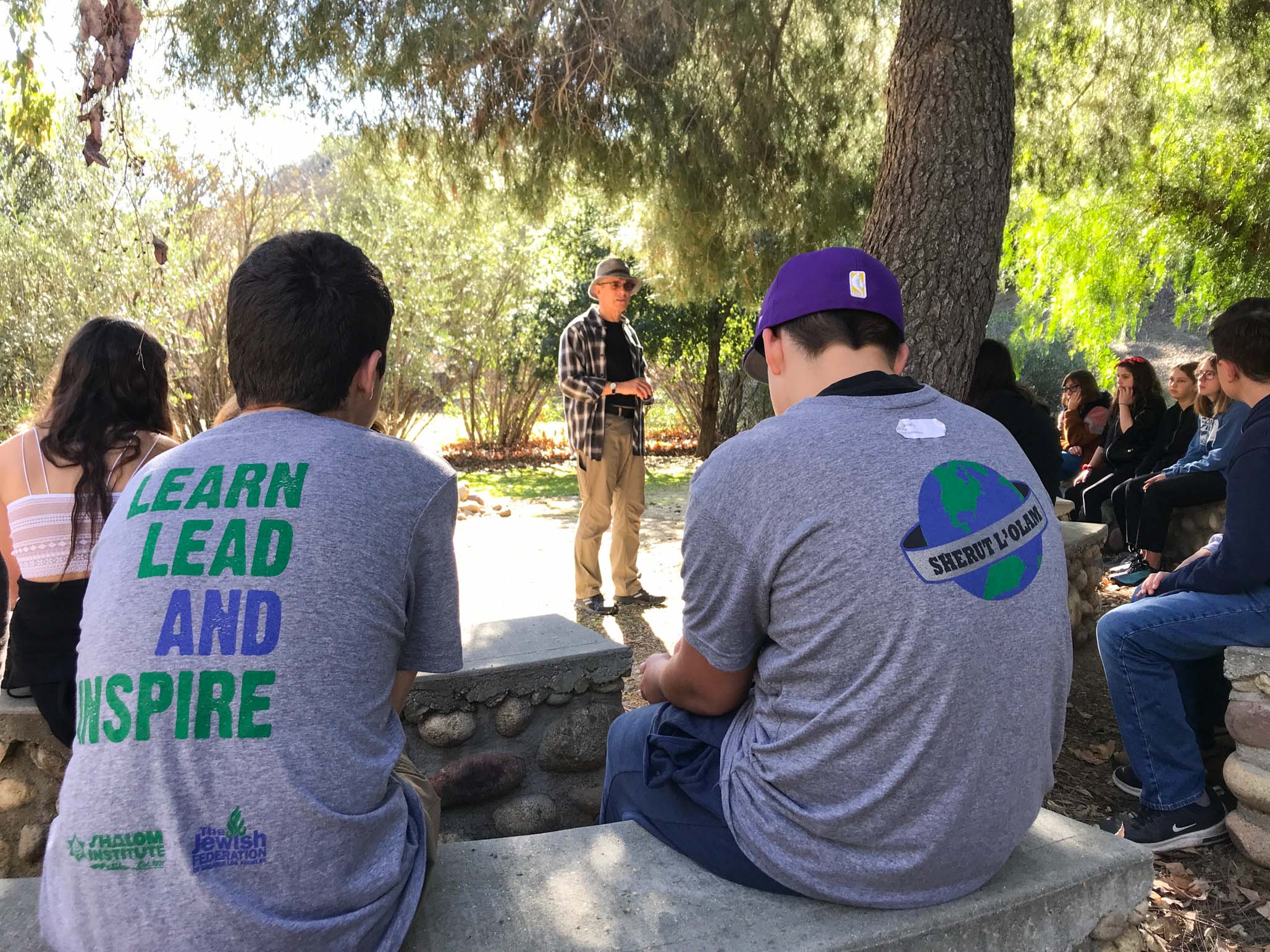 Kids sitting listening to instructor.