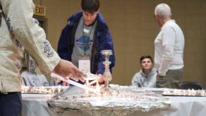 lighting candles on a table.