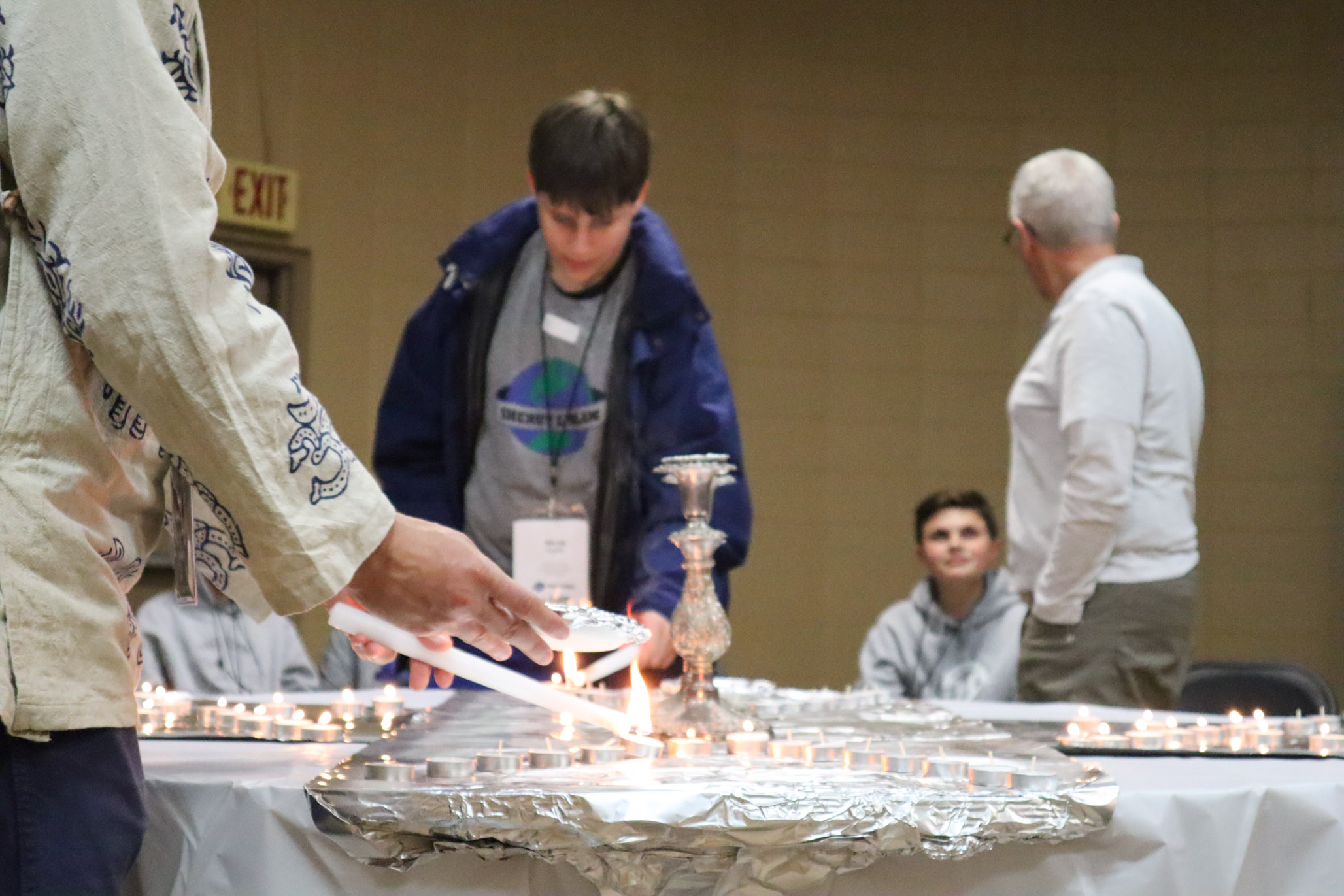 lighting candles on a table.