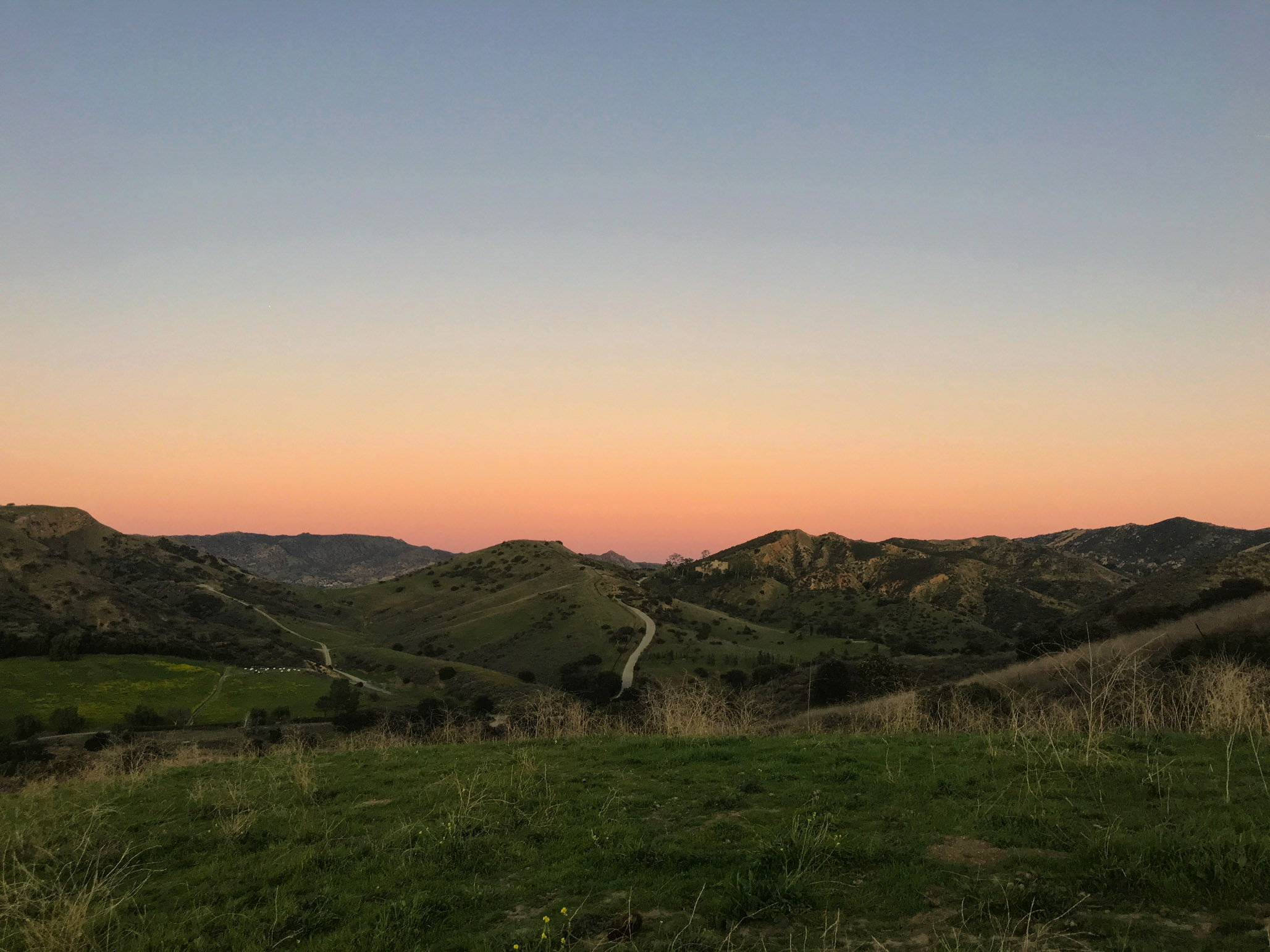sunset over rolling hills.