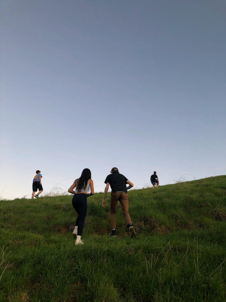 teens walking away up a hill.