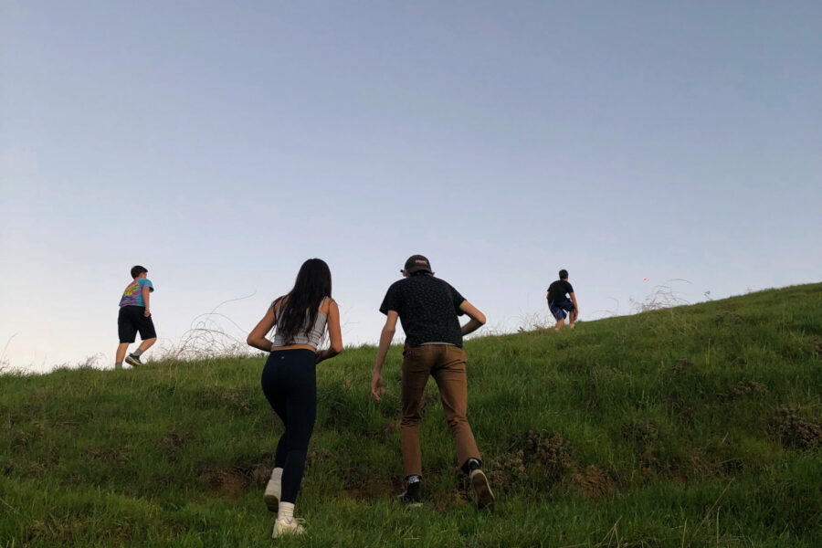 teens walking away up a hill.